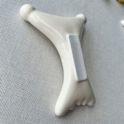 OEM/ODM Ceramica a forma di X Gua Sha Scraping Massaggiatore Salone di bellezza Essenziale per il rilassamento facciale